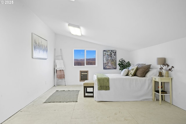 bedroom featuring lofted ceiling, concrete flooring, and heating unit