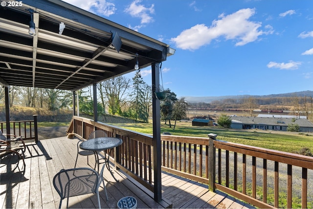 wooden terrace featuring a lawn