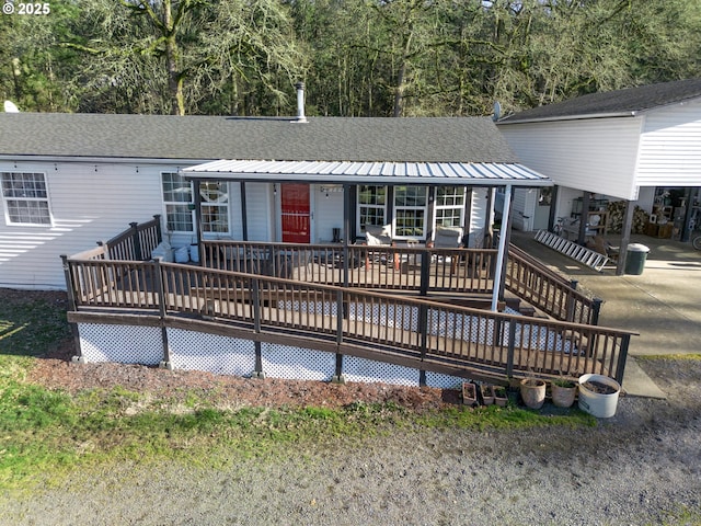 rear view of house featuring a deck