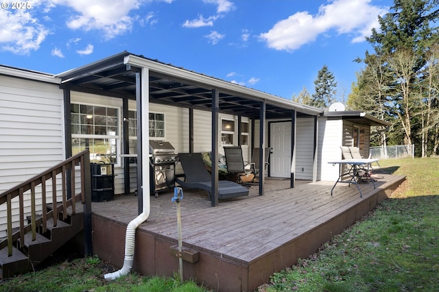 wooden terrace featuring a yard and grilling area