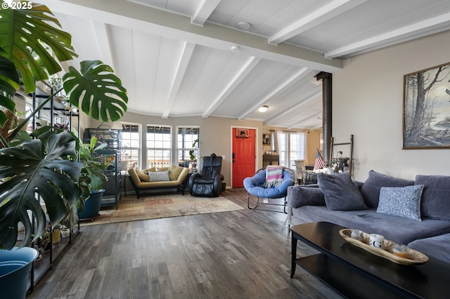 living room with hardwood / wood-style flooring and vaulted ceiling with beams