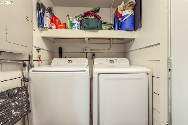 clothes washing area featuring independent washer and dryer and electric panel