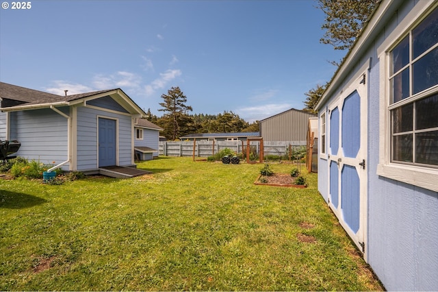 view of yard featuring a storage shed and an outbuilding
