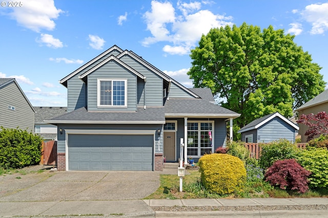 42015 NW Buckshire St, Banks, OR 97106 - view of front facade featuring roof with shingles, fence, an attached garage, brick siding, and concrete driveway