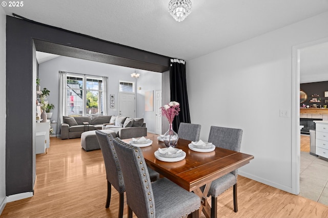 42015 NW Buckshire St, Banks, OR 97106 - dining room featuring baseboards, light wood finished floors, and a notable chandelier