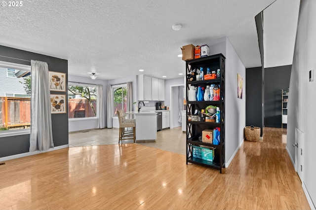 42015 NW Buckshire St, Banks, OR 97106 - interior space featuring white cabinets, a sink, light countertops, baseboards, and light wood-type flooring