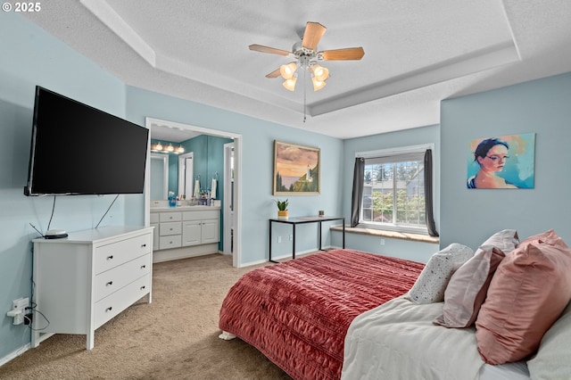 42015 NW Buckshire St, Banks, OR 97106 - bedroom with ceiling fan, a textured ceiling, light colored carpet, a raised ceiling, and connected bathroom