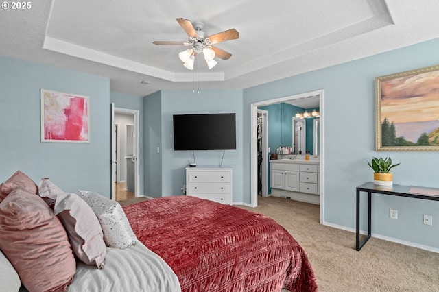 42015 NW Buckshire St, Banks, OR 97106 - bedroom featuring a ceiling fan, baseboards, connected bathroom, light carpet, and a tray ceiling