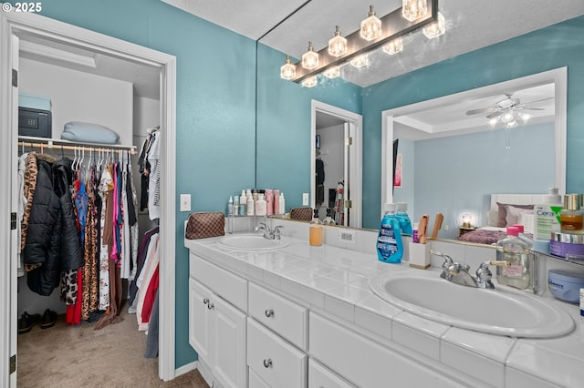 42015 NW Buckshire St, Banks, OR 97106 - bathroom featuring a sink, a walk in closet, a ceiling fan, and double vanity