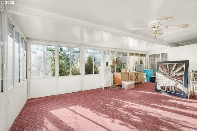 unfurnished sunroom with ceiling fan