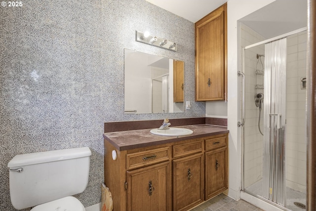 bathroom with vanity, toilet, and walk in shower