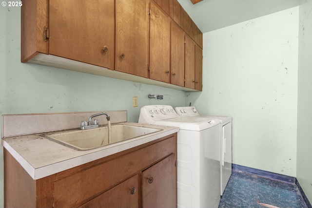 laundry room with cabinets, separate washer and dryer, and sink