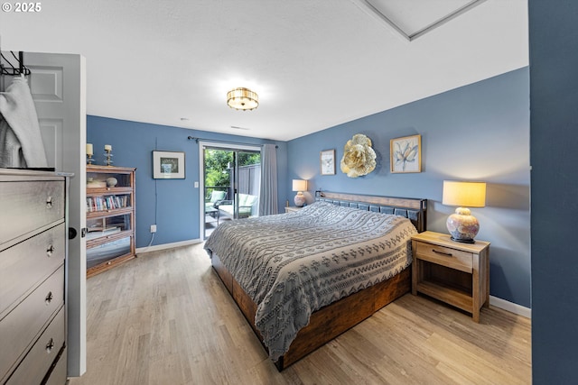 9333 SW 4th Ave, Portland, OR 97219 - bedroom with baseboards, access to outside, and light wood finished floors