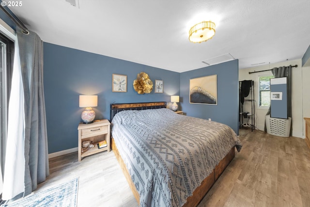 9333 SW 4th Ave, Portland, OR 97219 - bedroom featuring wood finished floors, attic access, and baseboards