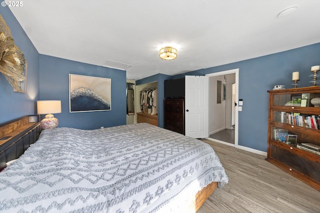 9333 SW 4th Ave, Portland, OR 97219 - bedroom with wood finished floors, baseboards, a closet, and attic access