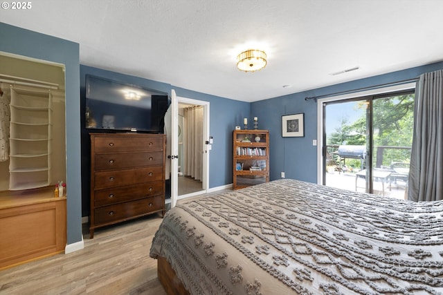 9333 SW 4th Ave, Portland, OR 97219 - bedroom featuring access to outside, light wood finished floors, and baseboards