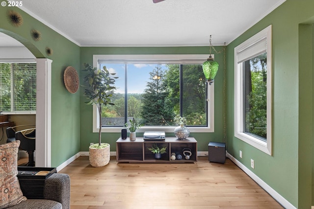 9333 SW 4th Ave, Portland, OR 97219 - sitting room featuring ornamental molding, wood finished floors, arched walkways, baseboards, and a textured ceiling