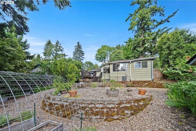 9333 SW 4th Ave, Portland, OR 97219 - view of yard with a garden, a wooden deck, and stairway