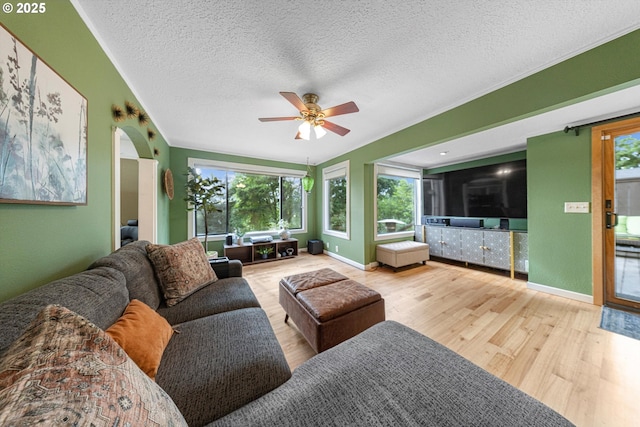 9333 SW 4th Ave, Portland, OR 97219 - living room with wood finished floors, ceiling fan, a textured ceiling, arched walkways, and baseboards