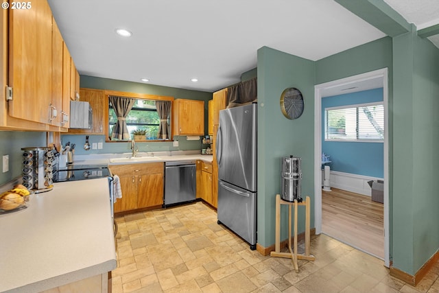 9333 SW 4th Ave, Portland, OR 97219 - kitchen with appliances with stainless steel finishes, a sink, light countertops, baseboards, and recessed lighting