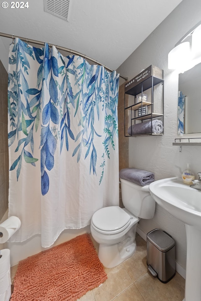 369 B St, Elkton, OR 97436 - full bath with tile patterned flooring, toilet, a sink, a textured wall, and shower / bath combo