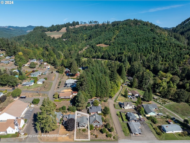 aerial view featuring a residential view, a mountain view, and a view of trees