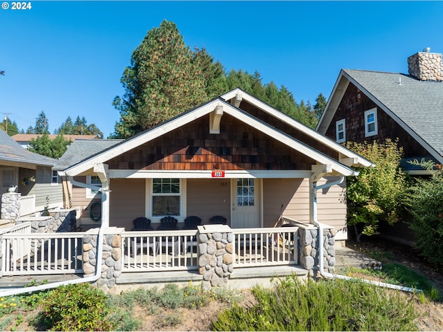 view of front of property with a porch and a chimney