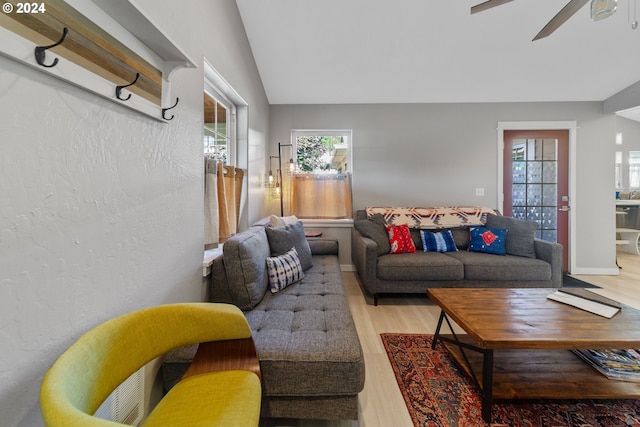 living room featuring lofted ceiling, plenty of natural light, ceiling fan, and wood finished floors