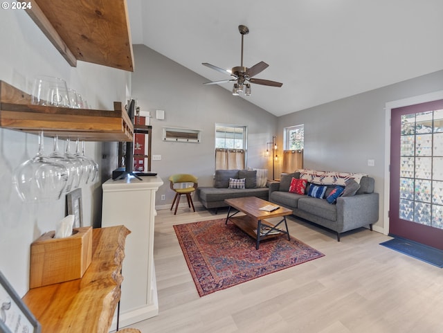 living room with high vaulted ceiling, light wood finished floors, a ceiling fan, and baseboards