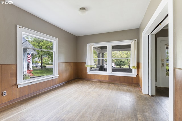 3003 SE 58th Ave, Portland, OR 97206 - spare room with wood finished floors, plenty of natural light, wainscoting, and wood walls