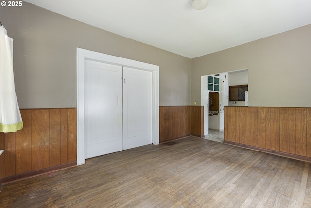 3003 SE 58th Ave, Portland, OR 97206 - unfurnished bedroom with wood finished floors, a closet, and a wainscoted wall