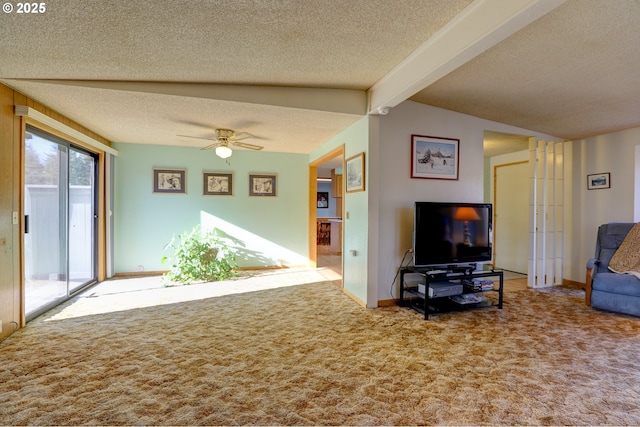 living area with a textured ceiling, ceiling fan, carpet flooring, and beam ceiling