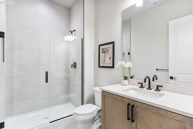 bathroom featuring walk in shower, vanity, and toilet