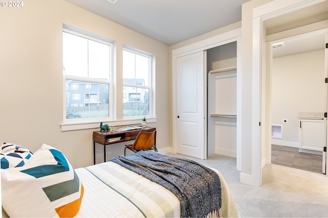 bedroom featuring a closet and light carpet