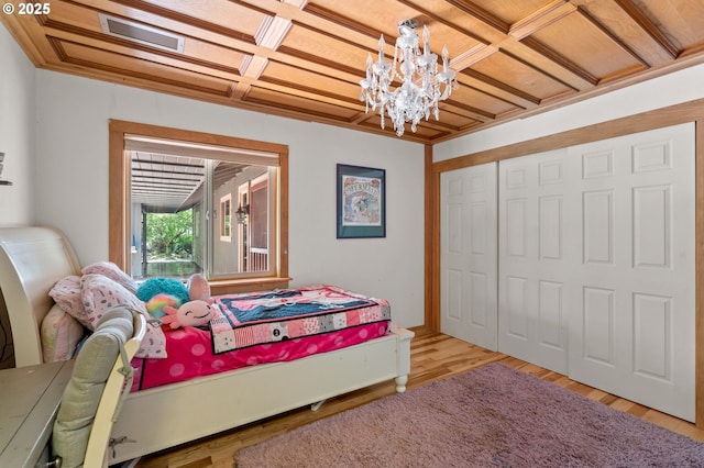 72794 Shoestring Rd, Cottage Grove, OR 97424 - bedroom featuring a chandelier, coffered ceiling, wood finished floors, and a closet