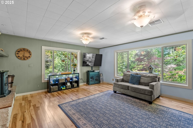 72794 Shoestring Rd, Cottage Grove, OR 97424 - living room featuring a wood stove, hardwood / wood-style flooring, and baseboards
