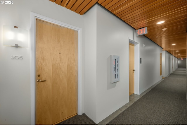 hall featuring recessed lighting, wooden ceiling, and carpet floors