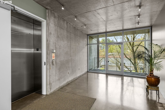 1234 SW 18th Ave Unit 305, Portland, OR 97205 - spare room with track lighting, plenty of natural light, expansive windows, and elevator