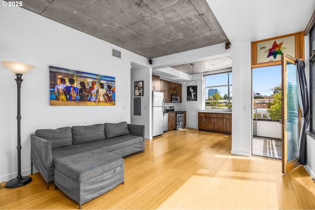 1234 SW 18th Ave Unit 305, Portland, OR 97205 - living room featuring baseboards, visible vents, light wood-style floors, and electric panel