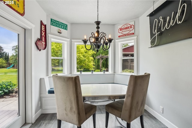 12875 Peggys Pl, Hubbard, OR 97032 - dining space with baseboards, a notable chandelier, and a wealth of natural light