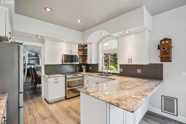 12875 Peggys Pl, Hubbard, OR 97032 - kitchen with a sink, stainless steel appliances, light wood-type flooring, and white cabinetry