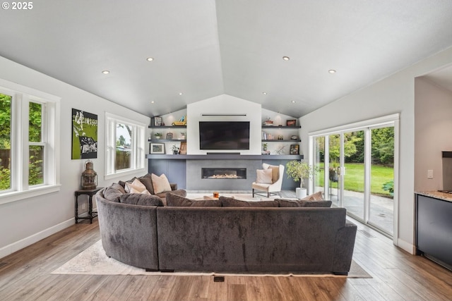 12875 Peggys Pl, Hubbard, OR 97032 - living area with a glass covered fireplace, baseboards, light wood finished floors, and lofted ceiling