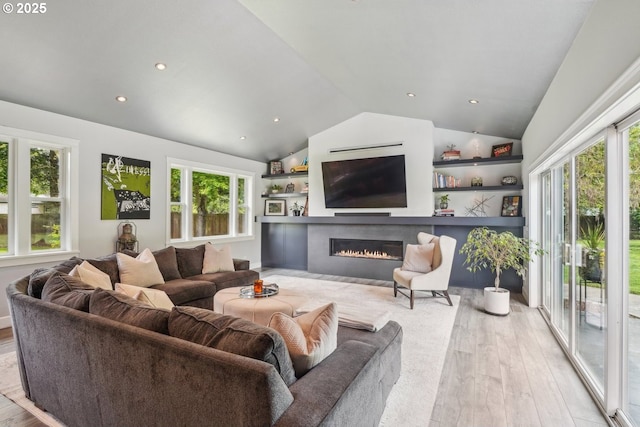 12875 Peggys Pl, Hubbard, OR 97032 - living room with light wood-style floors, plenty of natural light, vaulted ceiling, and a glass covered fireplace