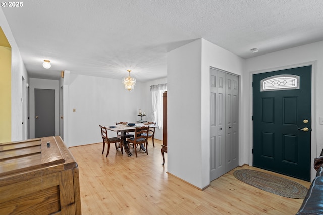 814 SW 44th St, Pendleton, OR 97801 - foyer entrance featuring a chandelier, light wood-style flooring, and a textured ceiling