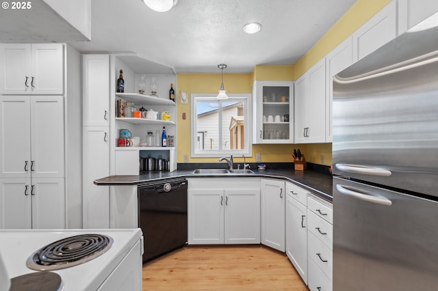 814 SW 44th St, Pendleton, OR 97801 - kitchen with freestanding refrigerator, black dishwasher, white cabinetry, white electric range oven, and light wood-style floors