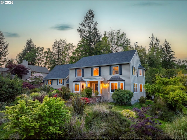 view of front of property featuring a shingled roof
