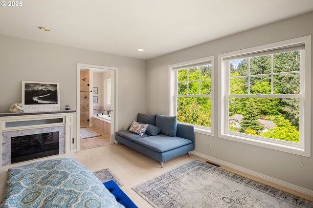 living room featuring visible vents, recessed lighting, baseboards, and a premium fireplace