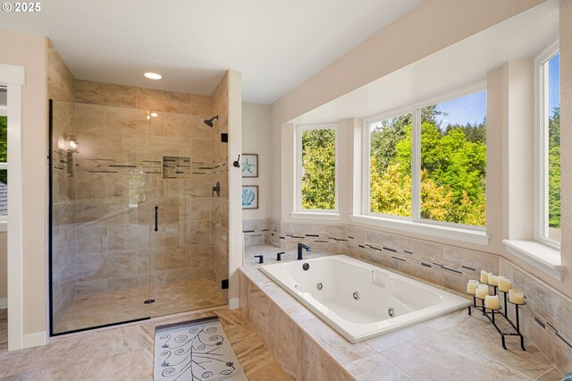 full bathroom with a whirlpool tub, baseboards, and a stall shower