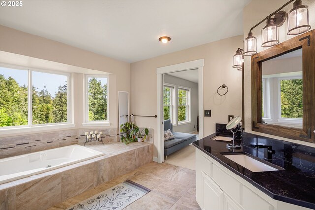 bathroom with tile patterned flooring, a bath, and vanity