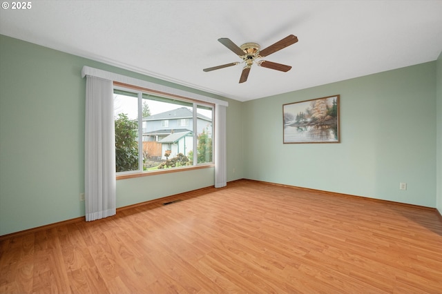 spare room featuring ceiling fan and light wood-type flooring